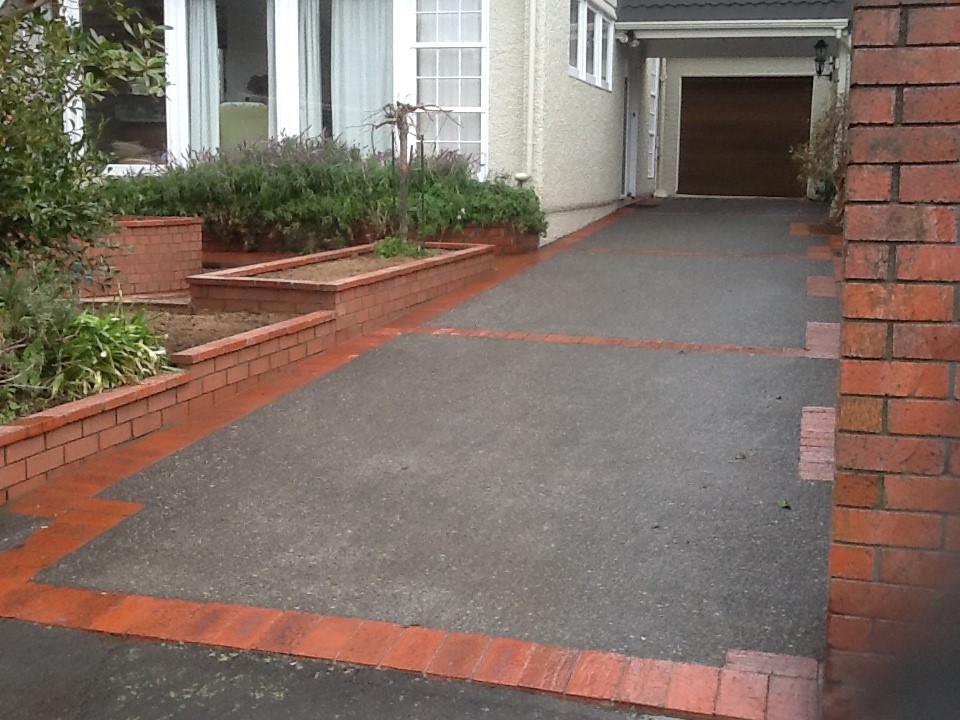 Exposed aggregate driveway finished with brick borders